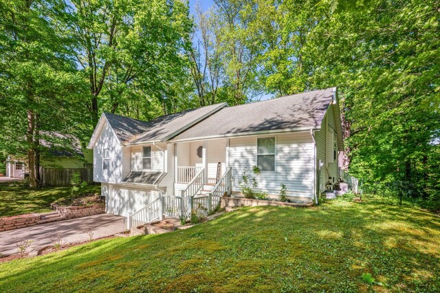 4085 Ravina Ter, Saint Joseph, MI 49085 - ranch-style home with a garage, concrete driveway, covered porch, and stairway