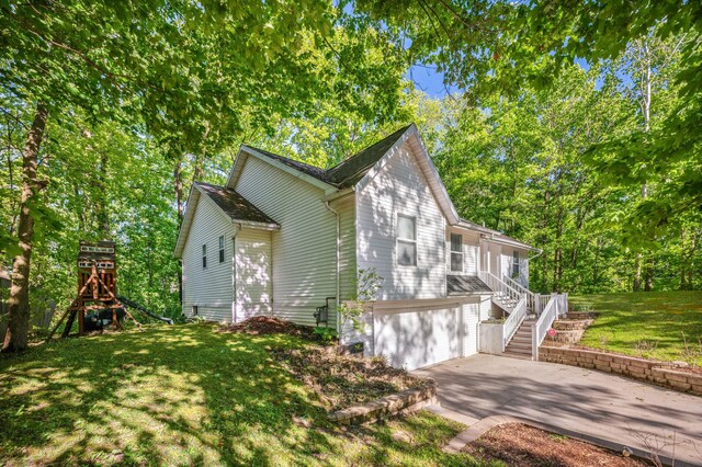 4085 Ravina Ter, Saint Joseph, MI 49085 - view of home's exterior with concrete driveway, stairway, a garage, and a yard