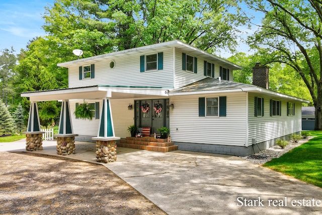 300 N 2nd Ave, Fruitport, MI 49415 - view of front of home featuring a chimney and a porch