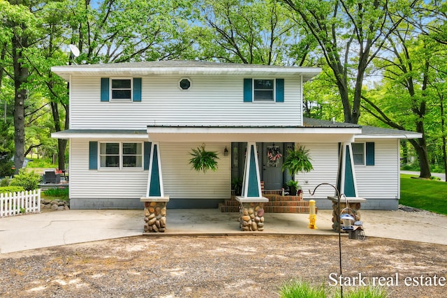 300 N 2nd Ave, Fruitport, MI 49415 - view of front of home featuring a porch and roof with shingles