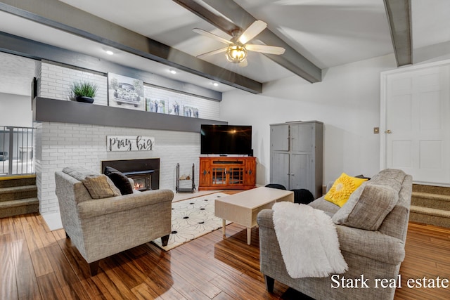 300 N 2nd Ave, Fruitport, MI 49415 - living area featuring beamed ceiling, ceiling fan, wood finished floors, stairs, and a brick fireplace