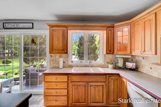 300 N 2nd Ave, Fruitport, MI 49415 - kitchen with a sink, stainless steel dishwasher, backsplash, and light countertops