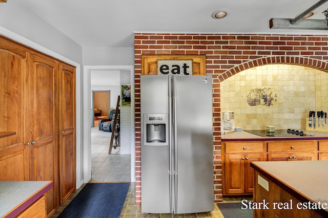 300 N 2nd Ave, Fruitport, MI 49415 - kitchen with stainless steel fridge with ice dispenser, black electric cooktop, light countertops, and tile patterned flooring