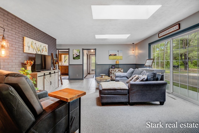 300 N 2nd Ave, Fruitport, MI 49415 - living area with a skylight, brick wall, light carpet, and wainscoting