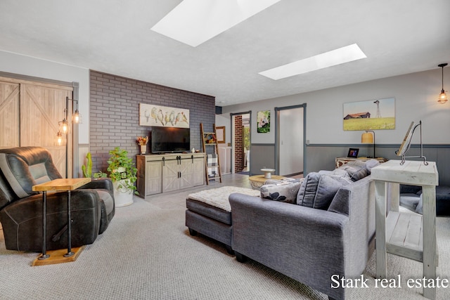 300 N 2nd Ave, Fruitport, MI 49415 - carpeted living area with a skylight, brick wall, and a wainscoted wall