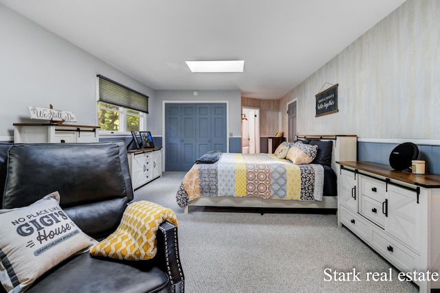 300 N 2nd Ave, Fruitport, MI 49415 - bedroom with a skylight, light colored carpet, and a closet