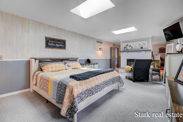 300 N 2nd Ave, Fruitport, MI 49415 - carpeted bedroom featuring a skylight, a brick fireplace, and wallpapered walls