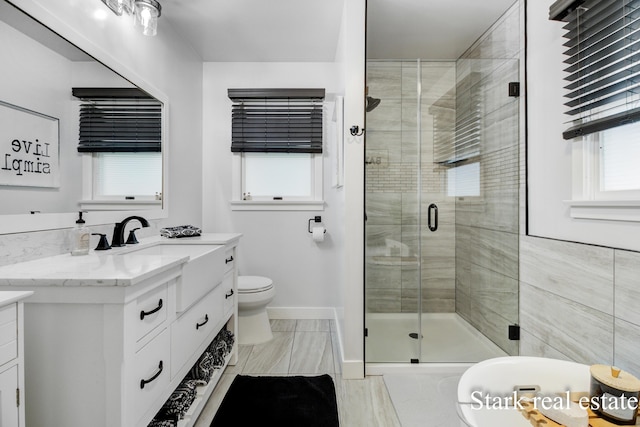300 N 2nd Ave, Fruitport, MI 49415 - full bath featuring vanity, a stall shower, toilet, and baseboards