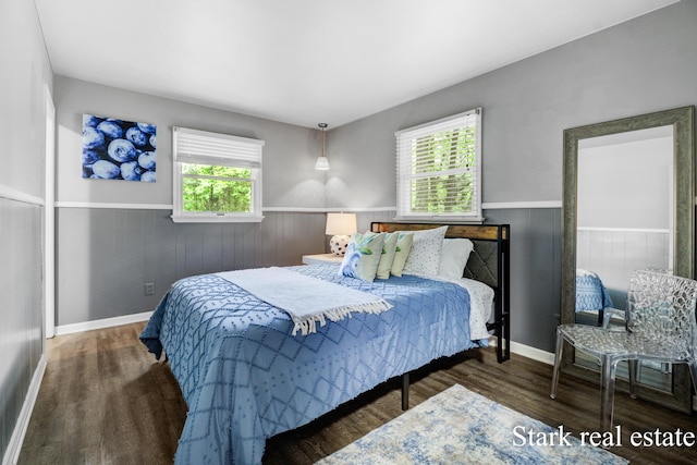 300 N 2nd Ave, Fruitport, MI 49415 - bedroom featuring a wainscoted wall, multiple windows, and wood finished floors