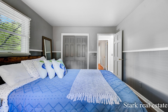 300 N 2nd Ave, Fruitport, MI 49415 - bedroom featuring wainscoting and a closet