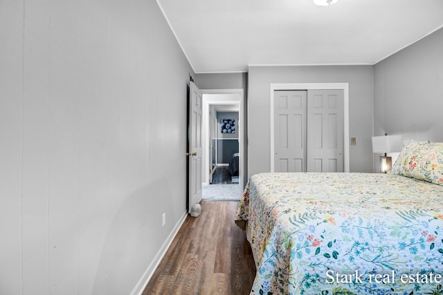 300 N 2nd Ave, Fruitport, MI 49415 - bedroom with wood finished floors, baseboards, and a closet