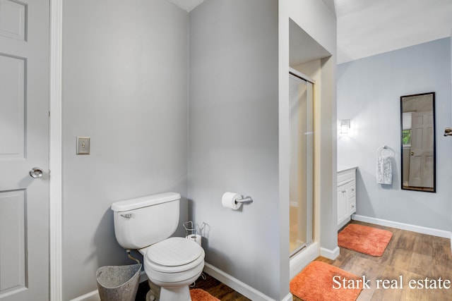 300 N 2nd Ave, Fruitport, MI 49415 - full bathroom with a shower stall, wood finished floors, baseboards, and toilet