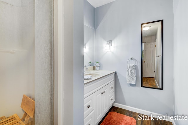 300 N 2nd Ave, Fruitport, MI 49415 - bathroom with vanity, wood finished floors, and baseboards