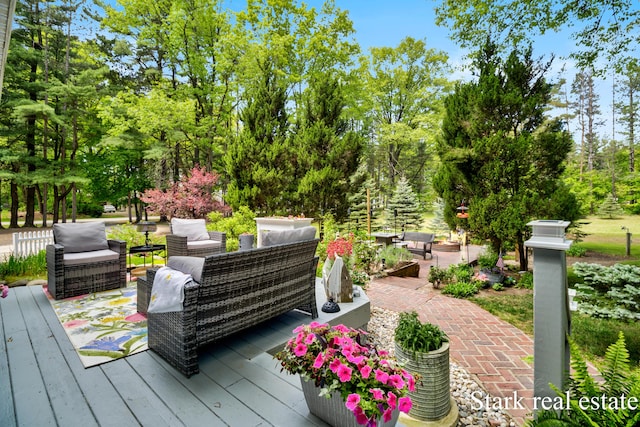 300 N 2nd Ave, Fruitport, MI 49415 - deck featuring an outdoor living space and view of scattered trees
