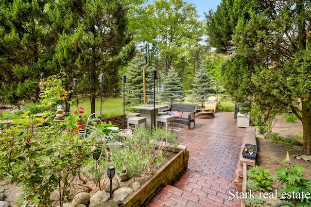 300 N 2nd Ave, Fruitport, MI 49415 - view of patio featuring an outdoor fire pit and a vegetable garden