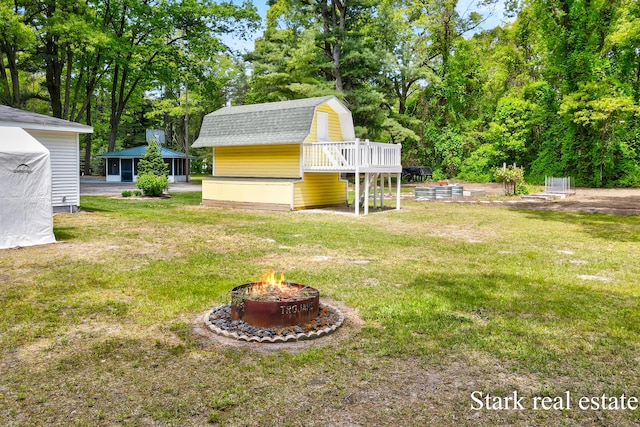 300 N 2nd Ave, Fruitport, MI 49415 - view of green lawn featuring an outdoor fire pit