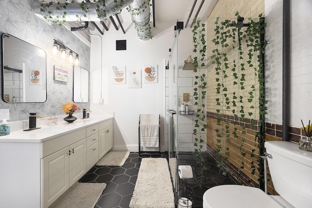 600 Broadway Ave NW Unit 117, Grand Rapids, MI 49504 - full bathroom featuring toilet, double vanity, a shower stall, and tile patterned flooring