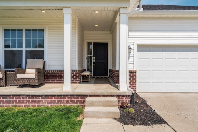 2771 Silo Dr, Saline, MI 48176 - view of exterior entry with covered porch, brick siding, a garage, and a shingled roof