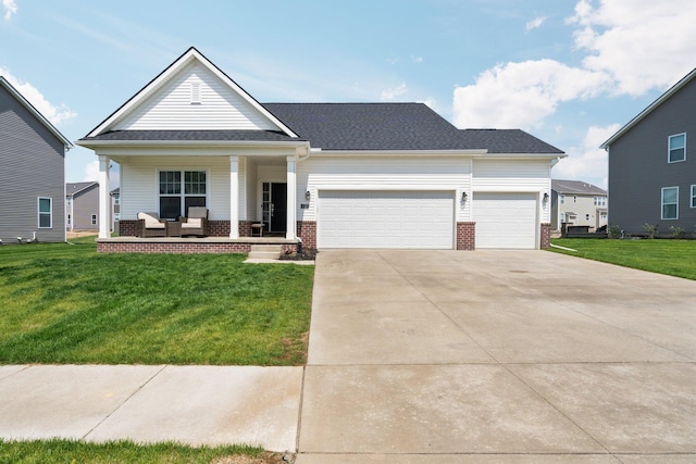 2771 Silo Dr, Saline, MI 48176 - view of front of house with covered porch, brick siding, a front yard, a garage, and driveway