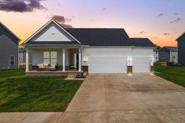 2771 Silo Dr, Saline, MI 48176 - view of front of house featuring a porch, a front yard, a garage, concrete driveway, and brick siding
