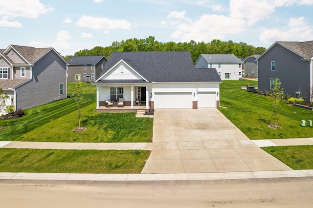 2771 Silo Dr, Saline, MI 48176 - view of front of home featuring covered porch, an attached garage, driveway, a front yard, and a residential view