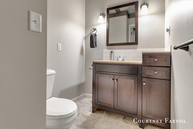414 135th Ave, Wayland, MI 49348 - half bath featuring toilet, baseboards, vanity, and tasteful backsplash
