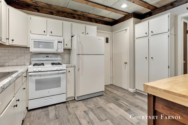 414 135th Ave, Wayland, MI 49348 - kitchen with white appliances, white cabinetry, light countertops, and light wood-style flooring
