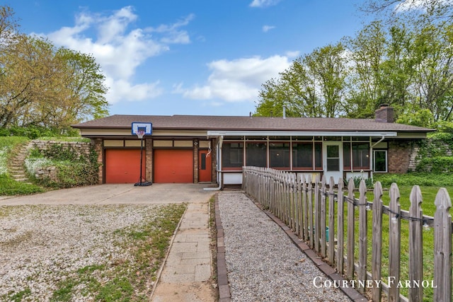 414 135th Ave, Wayland, MI 49348 - view of front of home featuring an attached garage, a sunroom, driveway, and a chimney