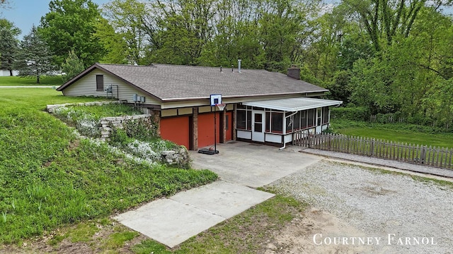 414 135th Ave, Wayland, MI 49348 - view of front facade with a sunroom, concrete driveway, and a chimney