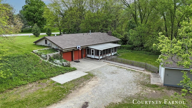 414 135th Ave, Wayland, MI 49348 - view of front facade with dirt driveway, a shingled roof, a chimney, and a sunroom