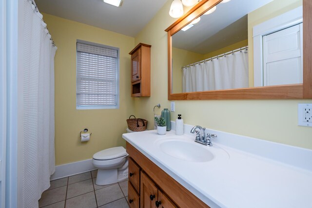 1701 Forres Ave, Saint Joseph, MI 49085 - bathroom with vanity, toilet, tile patterned floors, baseboards, and a shower with shower curtain