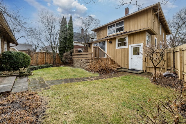 1701 Forres Ave, Saint Joseph, MI 49085 - back of property featuring a chimney, a deck, board and batten siding, and stairway