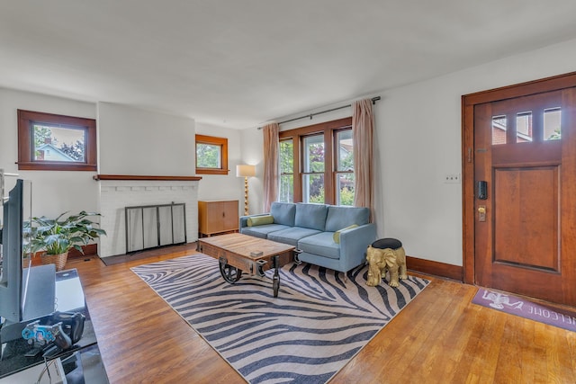710 S 1st St, Ann Arbor, MI 48103 - living room with wood finished floors, baseboards, and a brick fireplace