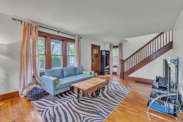 710 S 1st St, Ann Arbor, MI 48103 - living room with wood finished floors, stairs, and baseboards