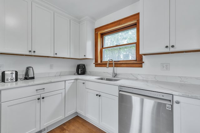 710 S 1st St, Ann Arbor, MI 48103 - kitchen featuring stainless steel dishwasher, a sink, white cabinets, light stone counters, and light wood-style floors