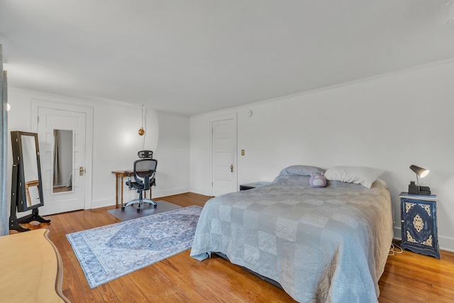 710 S 1st St, Ann Arbor, MI 48103 - bedroom featuring wood finished floors, baseboards, and crown molding