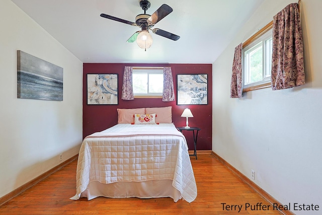 2576 Vine Ave, Muskegon, MI 49442 - bedroom featuring multiple windows, wood finished floors, and baseboards