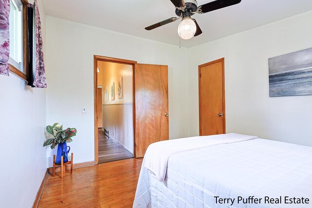 2576 Vine Ave, Muskegon, MI 49442 - bedroom with light wood-style floors, a ceiling fan, and baseboards