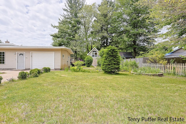 2576 Vine Ave, Muskegon, MI 49442 - view of yard featuring an attached garage and driveway