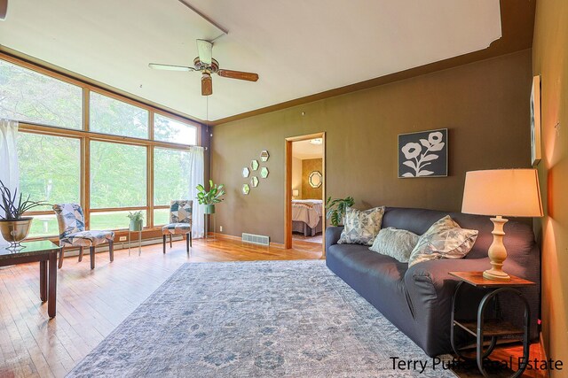 2576 Vine Ave, Muskegon, MI 49442 - living room featuring a ceiling fan, wood finished floors, and baseboards
