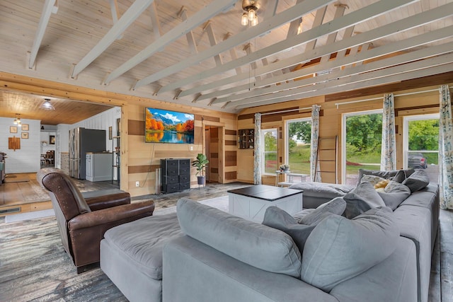 9410 US Highway 12, Brooklyn, MI 49230 - living room featuring wooden walls, healthy amount of natural light, wood finished floors, and beamed ceiling