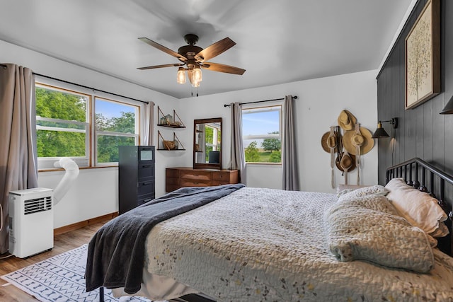 9410 US Highway 12, Brooklyn, MI 49230 - bedroom featuring multiple windows, light wood-style flooring, baseboards, and ceiling fan