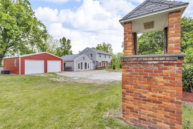 9410 US Highway 12, Brooklyn, MI 49230 - view of green lawn with an outbuilding, a detached garage, and central AC