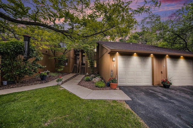 7643 Cottonwood Ln, Dexter, MI 48130 - view of front facade with driveway, an attached garage, and a front lawn