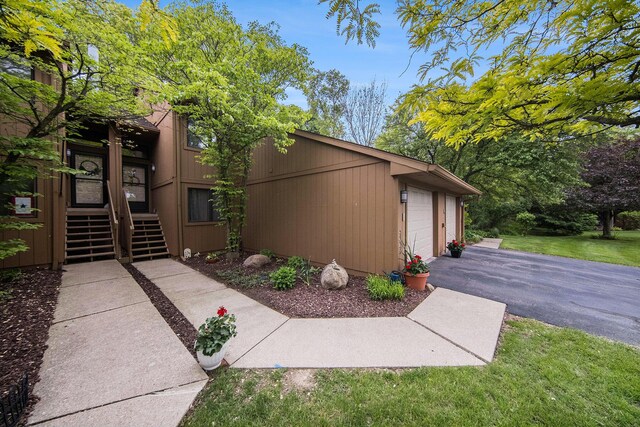 7643 Cottonwood Ln, Dexter, MI 48130 - view of side of property with asphalt driveway