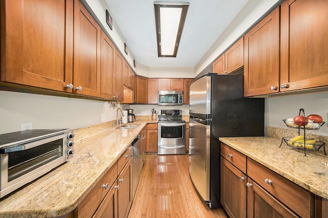 7643 Cottonwood Ln, Dexter, MI 48130 - kitchen with appliances with stainless steel finishes, a sink, and brown cabinets