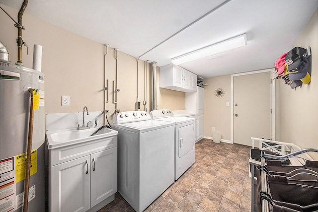 7643 Cottonwood Ln, Dexter, MI 48130 - laundry room featuring washing machine and dryer, water heater, cabinet space, and stone finish flooring