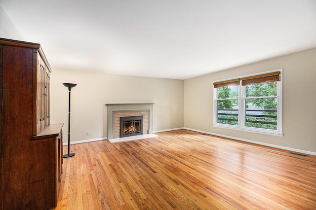 1231 Naples Ct, Ann Arbor, MI 48103 - unfurnished living room with light wood-type flooring, a fireplace, and baseboards