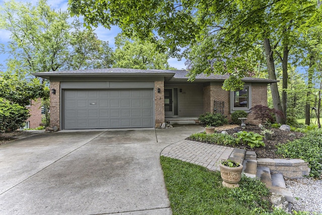 1231 Naples Ct, Ann Arbor, MI 48103 - view of front facade featuring brick siding, driveway, and a garage