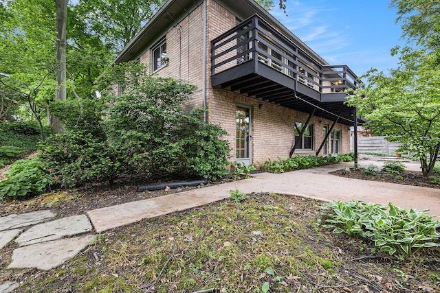 1231 Naples Ct, Ann Arbor, MI 48103 - rear view of house with brick siding and a balcony